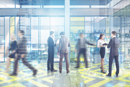 people walking through office lobby